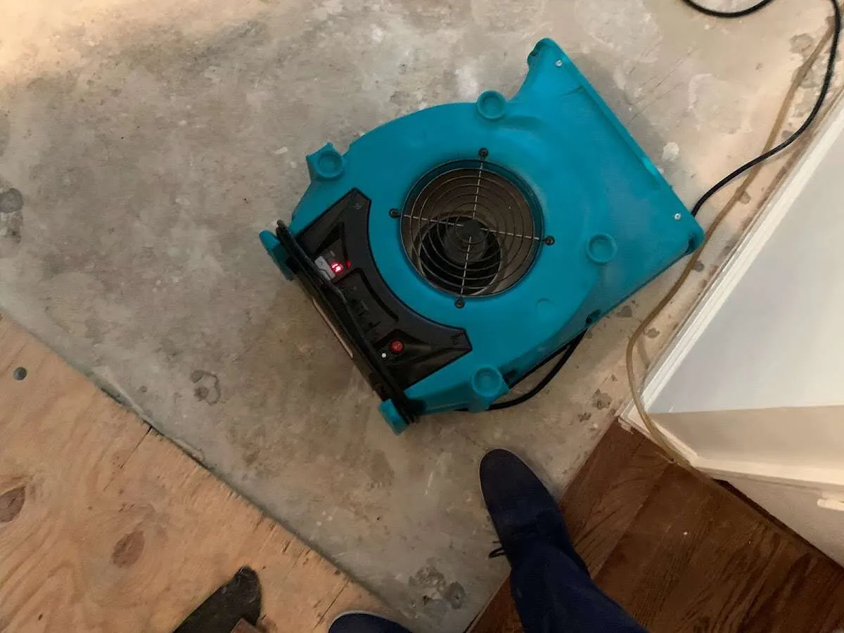 Air mover drying subfloor during Commercial Water Damage Restoration in West Boylston